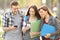 Three students checking smart phones