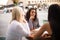 Three students girls in cafe talking