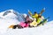 Three students in snow with snowboards