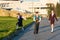 Three students walk in the park with portfolios after classes