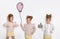 Three stunning beautiful little girls with long blond hair standing on a white background and one of them holds a balloon, the sec