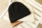 Three stylish beanies on wooden chair, top view