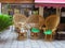 Three stylish brown wicker chairs in backyard patio