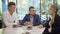 Three successful people sitting in cafe and talking. Portrait of confident Caucasian men and woman discussing