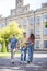 Three sudents walking in the college yard and talking