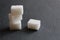 Three sugar cubes are stacked on top of each other or in a pyramid on a white gray and black background with space for inserting t