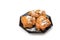 Three sugared fried fritters or oliebollen on saucer