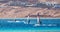 Three surfers compete in the Red Sea in the lagoon in Egypt Dahab