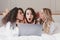 Three surprised women 20s wearing white bathrobe lying in luxury