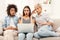 Three surprised women using laptop at home