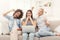 Three surprised women using laptop at home