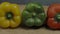 Three sweet peppers. Three colorful bell peppers red yellow and green colors in a row