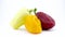 Three sweet peppers - white, yellow and red. Rotating on the turntable. Isolated on the white background. Close-up