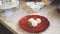 Three sweets are on a red glass plate with a piece of mint