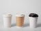 Three takeaway paper cups mockup on white background.