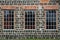 Three tall windows in a cinder block building