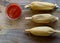 Three tamales on Wooden table from above