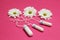 Three tampons on a pink background with white flowers