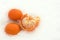 Three tangerines on white snow. White background. Symbol of the New Year and Christmas. Citrus. Vitamin C. Top view