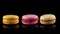 Three tasty colorful macarons rotating