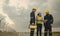 Three technician engineer in uniform with standing and checking wind turbine power farm power generator Station. Clean energy and