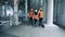 Three technicians are walking along the distillery premises