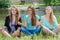 Three teen girls sitting in yoga position and meditating