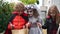 Three teenage children in make-up and costumes celebrate Halloween. Kids collect candy, halloween traditions