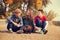 Three teenage friends have a fun time in golden autumn day
