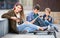 Three teenagers with phones outdoors