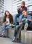 Three teenagers with phones outdoors