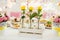 Three tellow roses in glass vasen on fancy decorated table