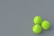 Three tennis balls on gray background. International championship