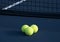 Three Tennis Balls on a Tennis Court