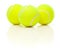 Three Tennis Balls on White with Slight Reflection
