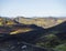 Three tents alone in Botnar campsite at Iceland on Laugavegur hiking trail, green valley in volcanic landscape among