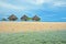 Three thatched huts on the beach by the sea