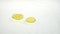 Three thin slices of lemon roll on the water. White background. Slow motion