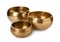 Three Tibetan singing bowls on white background