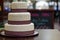 Three tier white burgundy wedding cake with pattern and silver pearls