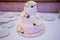 Three tier white wedding cake with decor and flowers