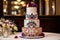 three-tiered wedding cake with intricate detailing and embellishments