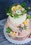 Three-tiered wedding ombre cake decorated with roses and greener