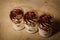 Three tiramisu desserts with pomegranate grains in plastic cups