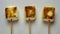 Three Toasted Marshmallows On Sticks Against A Neutral Background