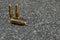 three Tokarev pistol (TT) cartridges on a gray granite background