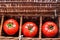 Three tomatoes in wicker box