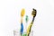 Three toothbrushes for the whole family, for mom, dad, baby in a glass close-up on a white background, dentist day