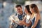 Three tourists checking map in a town