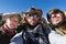 Three tourists two men woman selfie.